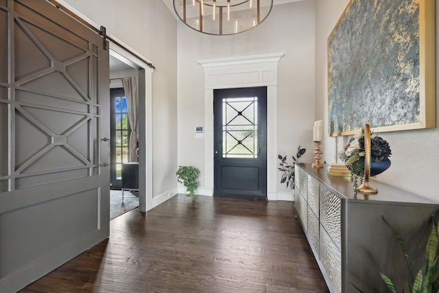 entrance foyer featuring a healthy amount of sunlight, dark wood-type flooring, and a barn door