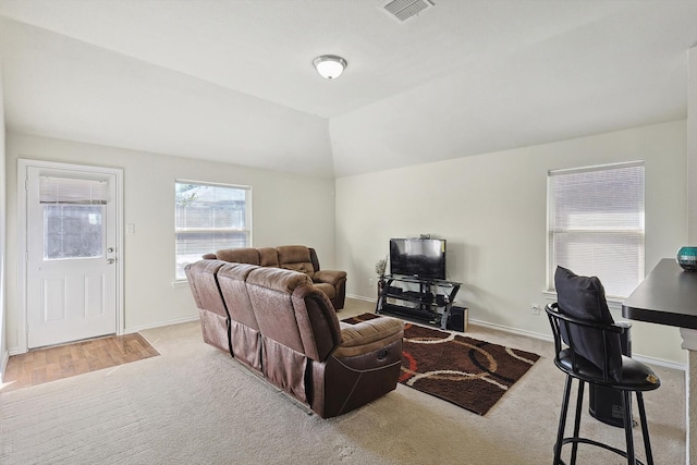 carpeted living room with vaulted ceiling