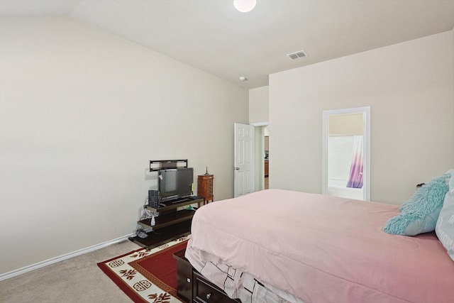 bedroom featuring light carpet and lofted ceiling