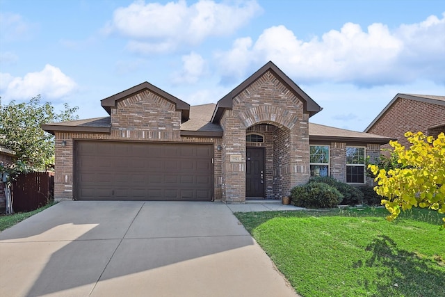 view of front of home with a garage and a front lawn