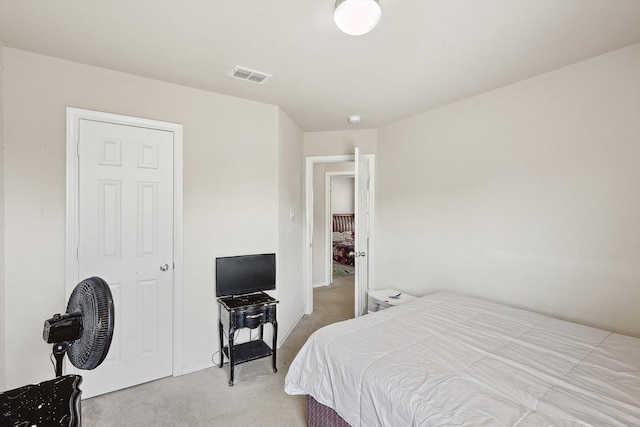 bedroom featuring light colored carpet