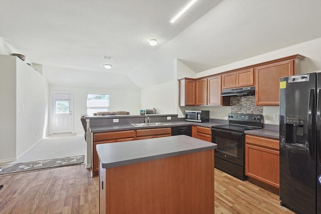 kitchen with lofted ceiling, black appliances, sink, light hardwood / wood-style floors, and kitchen peninsula