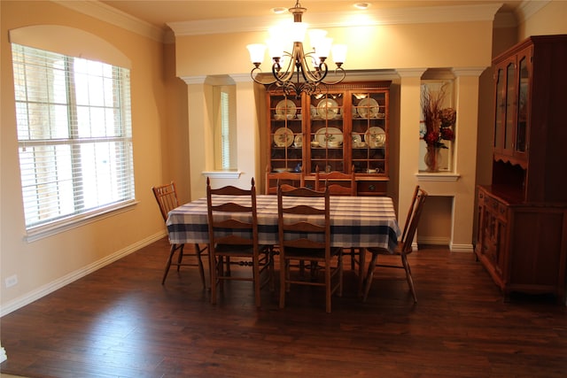 dining area featuring ornamental molding, dark hardwood / wood-style floors, ornate columns, and a notable chandelier