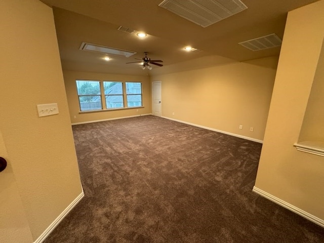 interior space with ceiling fan and dark carpet