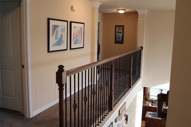 stairway featuring carpet and decorative columns