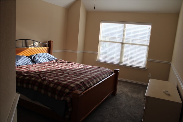 carpeted bedroom with lofted ceiling