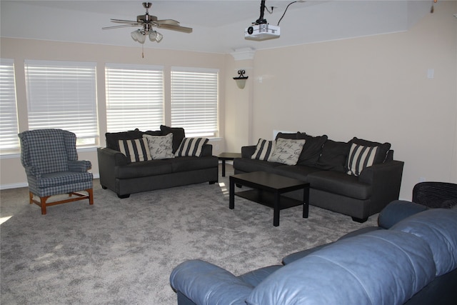 carpeted living room with ceiling fan