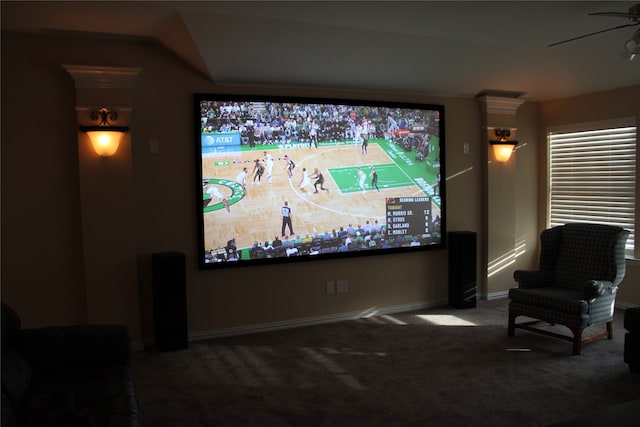 carpeted home theater room featuring ceiling fan