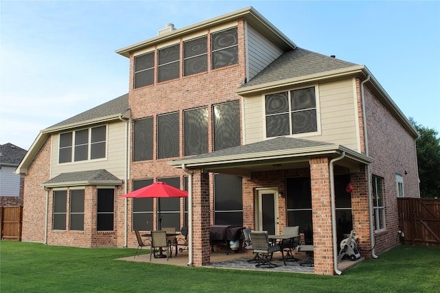 back of property featuring a yard and a patio area