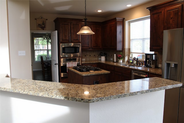 kitchen with stainless steel appliances, backsplash, light stone counters, and sink