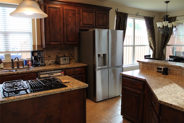 kitchen with stainless steel refrigerator with ice dispenser, sink, dishwasher, black gas stovetop, and backsplash