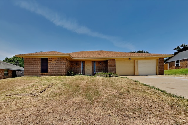 ranch-style house featuring a front yard and a garage