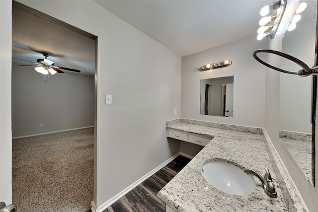 bathroom with ceiling fan, hardwood / wood-style flooring, and vanity