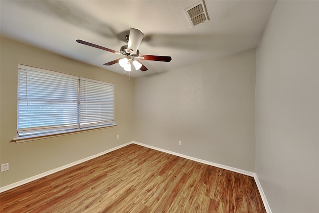 empty room featuring ceiling fan and hardwood / wood-style floors