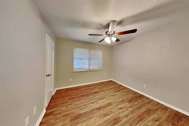 empty room featuring ceiling fan and hardwood / wood-style floors