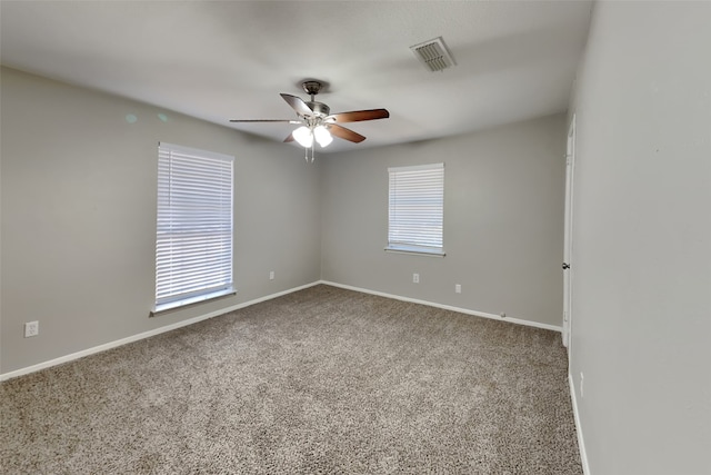 unfurnished room featuring ceiling fan and carpet floors