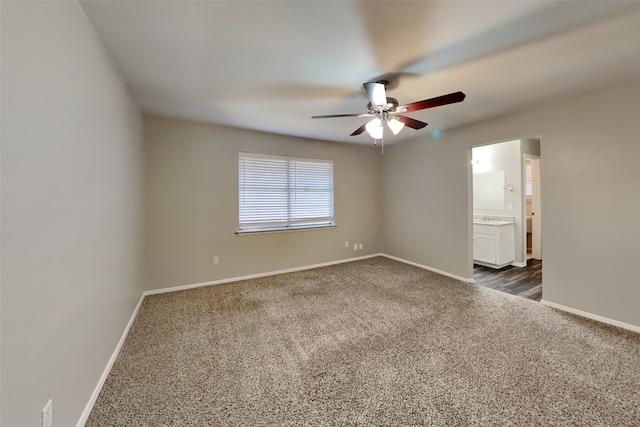 carpeted spare room with ceiling fan