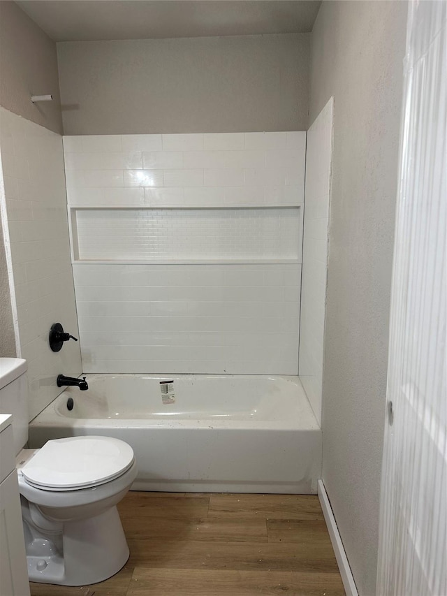 full bathroom featuring toilet, hardwood / wood-style flooring, bathtub / shower combination, and vanity