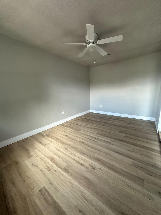 unfurnished room with ceiling fan and hardwood / wood-style floors