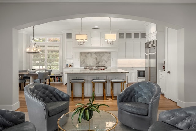 living room featuring light wood-type flooring and a chandelier