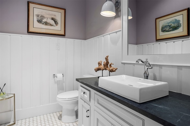 bathroom with tile flooring, vanity, and toilet