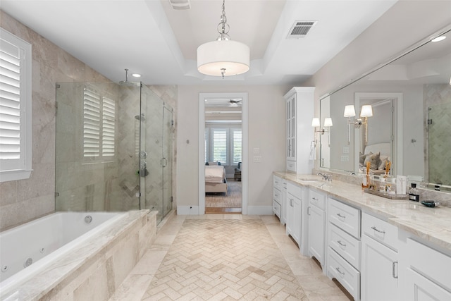 bathroom with a raised ceiling, dual vanity, separate shower and tub, and tile floors