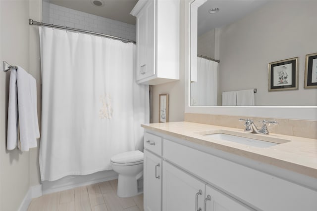 bathroom with tile floors, vanity, and toilet