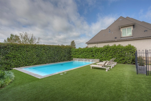 view of pool with a lawn