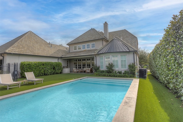 view of pool with a yard