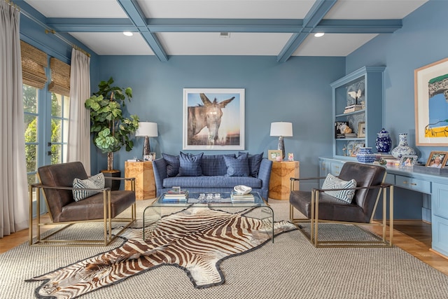 living room featuring beam ceiling, light hardwood / wood-style floors, and coffered ceiling