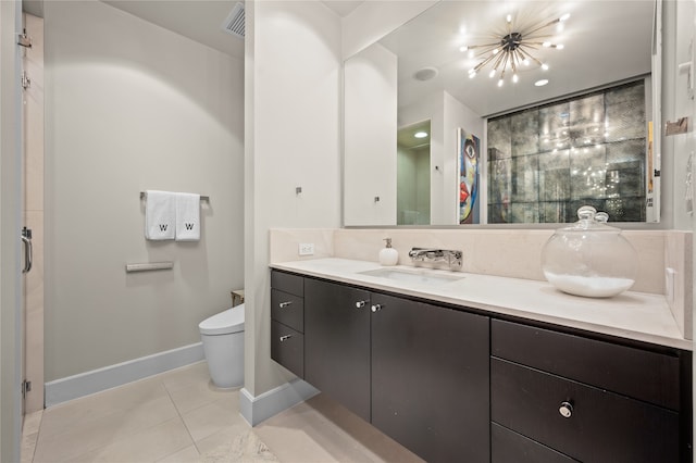 bathroom featuring tile floors, vanity, and toilet