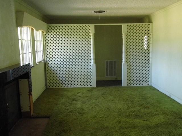 carpeted spare room with a textured ceiling and ornamental molding