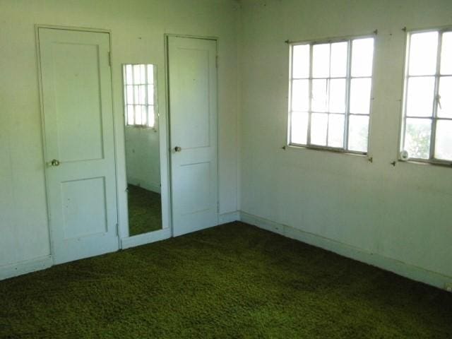 unfurnished bedroom featuring dark colored carpet