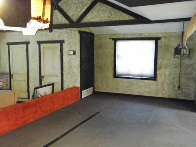 interior space featuring lofted ceiling with beams