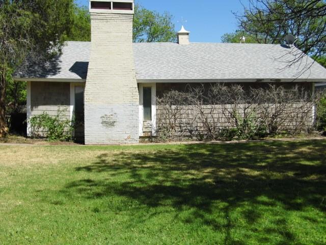 back of house with a lawn