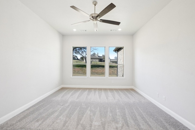 carpeted empty room featuring ceiling fan