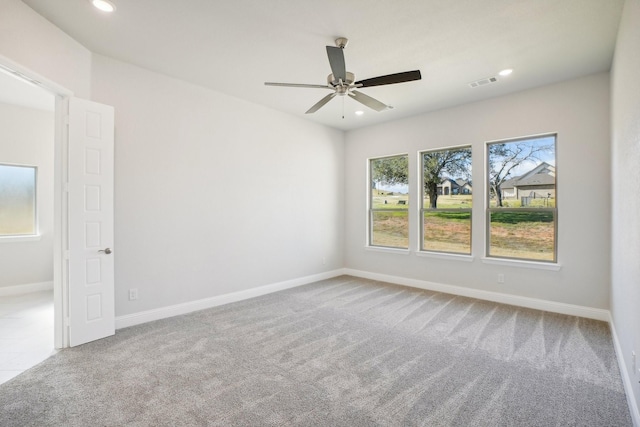 unfurnished room with carpet and ceiling fan