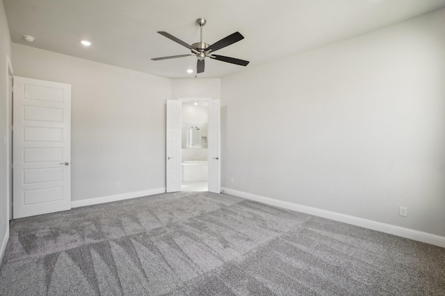 carpeted spare room with ceiling fan