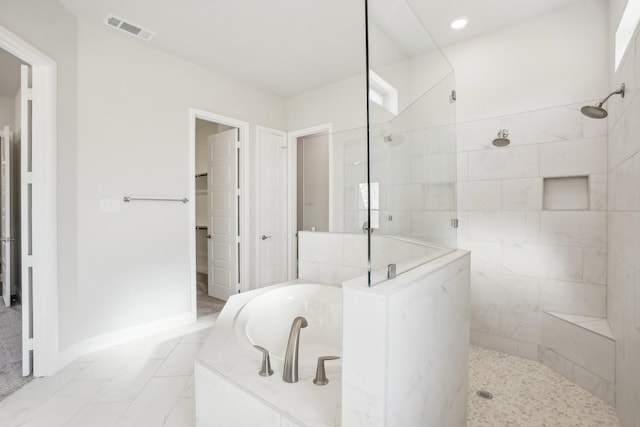 bathroom featuring separate shower and tub