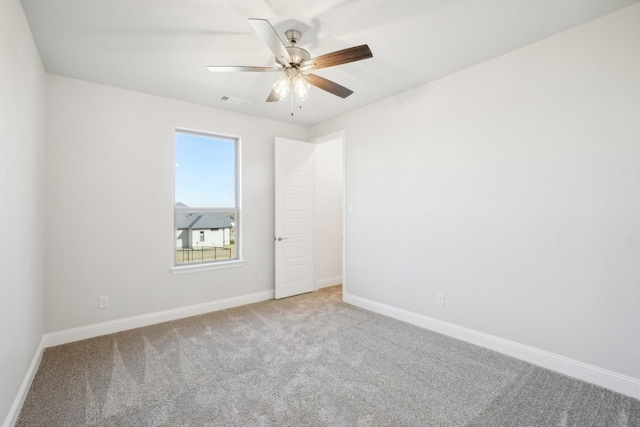 spare room featuring ceiling fan and light colored carpet