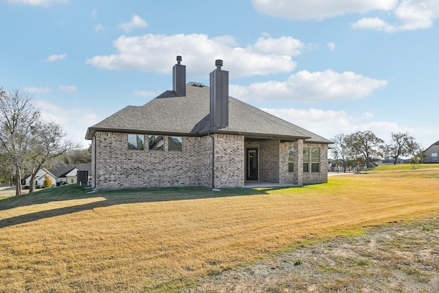 rear view of house featuring a yard