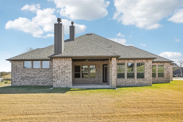 rear view of house with a patio area and a lawn