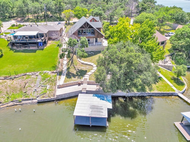 exterior space with a water view and a lawn