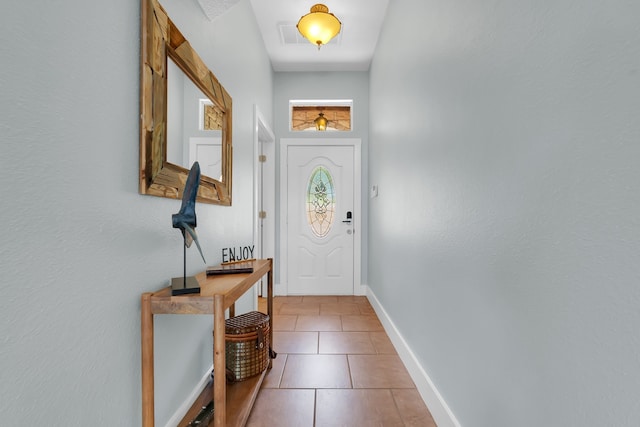 doorway to outside featuring tile flooring