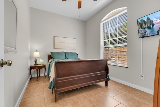 tiled bedroom featuring ceiling fan