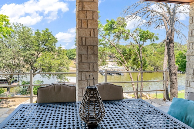 view of terrace with a water view