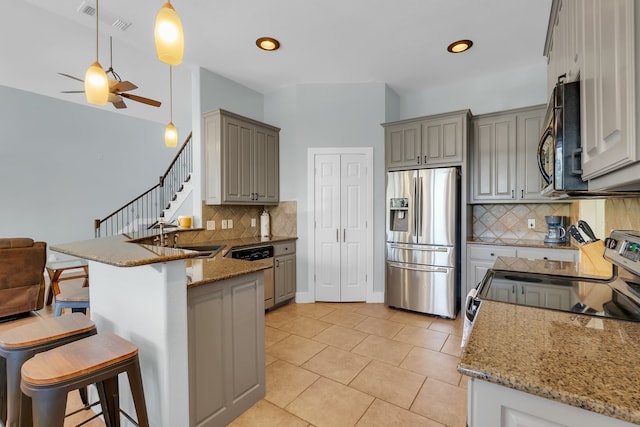 kitchen featuring stainless steel fridge with ice dispenser, dishwasher, hanging light fixtures, ceiling fan, and tasteful backsplash