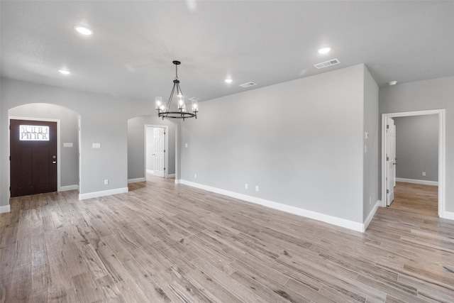 interior space with a chandelier and light hardwood / wood-style floors