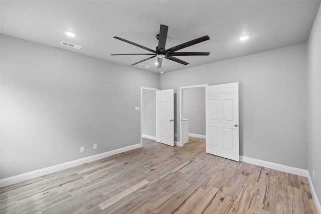 unfurnished bedroom with ceiling fan and light wood-type flooring