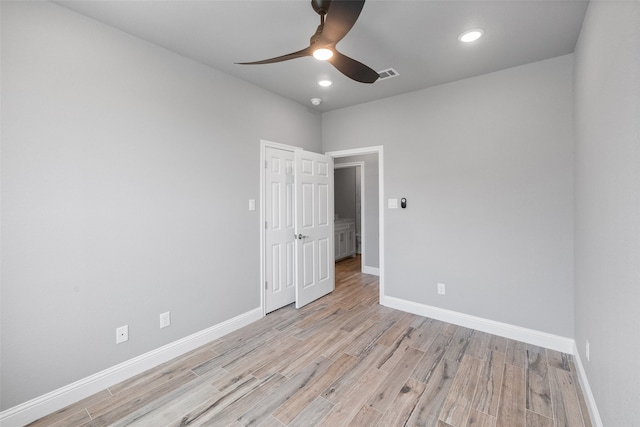 empty room featuring ceiling fan and light hardwood / wood-style floors